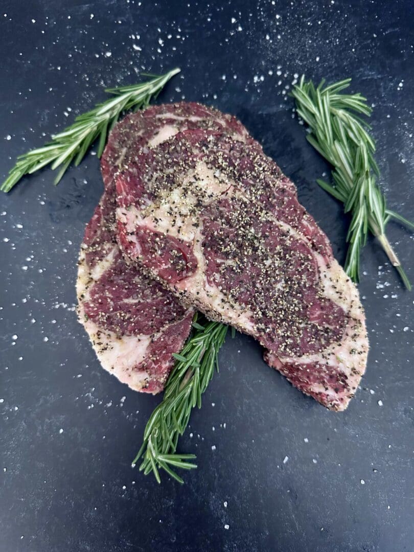 A piece of meat with herbs on it