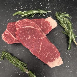A piece of meat with some herbs on it
