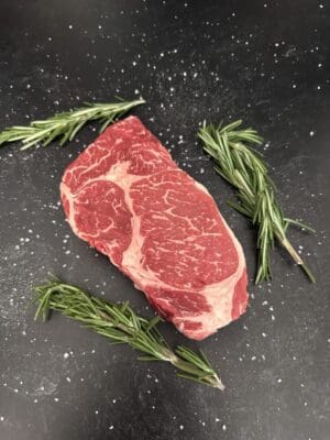 A piece of meat with some herbs on it