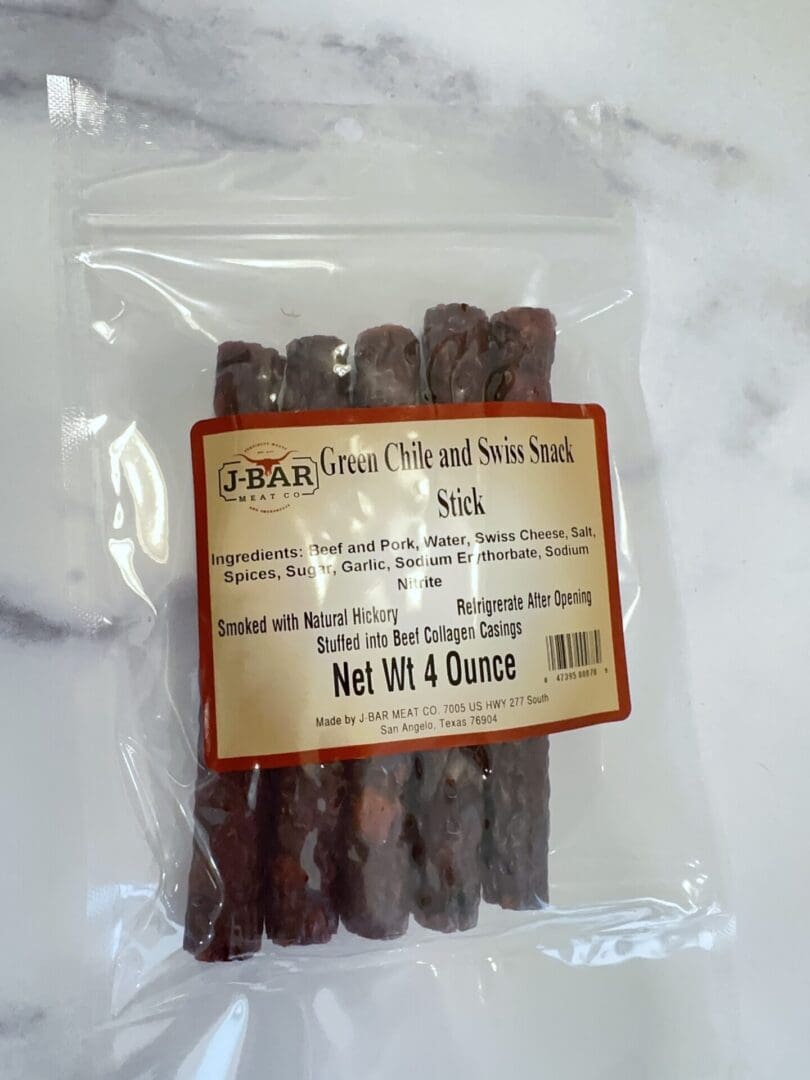A bag of chocolate covered sticks on top of a table.