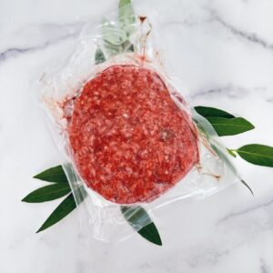 A package of ground meat on top of a marble table.
