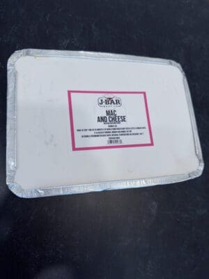 A white plastic container with a red label.