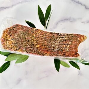 A piece of meat on top of a white plate.