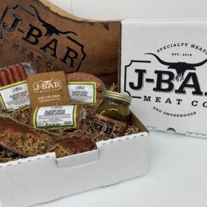 A box of meat and condiments sitting on top of a table.