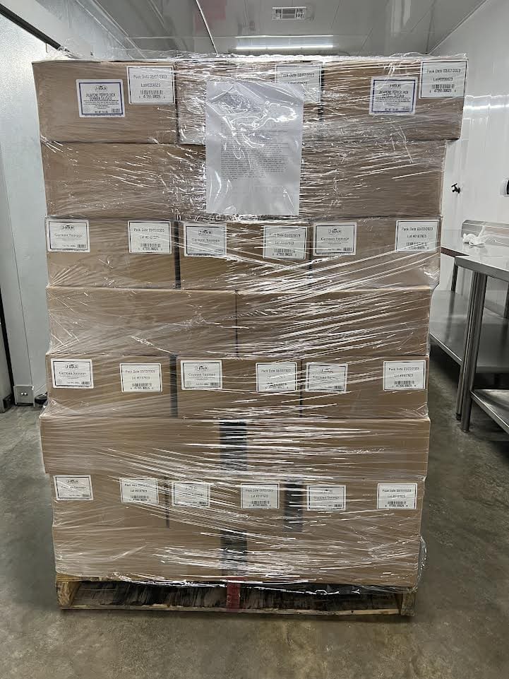 A pallet of boxes wrapped in plastic
